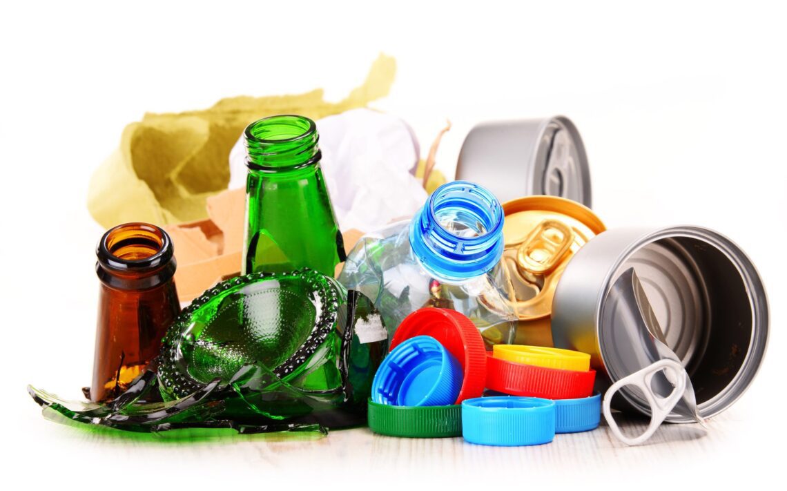 examples of plastic glass metal and cardboard packaging ready for recycling
